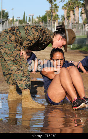 Marine Corps Drill Instructor Staff Sgt. Adrianna Medina motivates a poolee from Recruiting Sub Station Santa Clarita during Initial Strength Tests March 12, 2016 in Van Nuys, California. Stock Photo