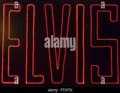 A photograph of a neon signing saying 'ELVIS'. The photograph was taken in Memphis, Tennessee. Stock Photo