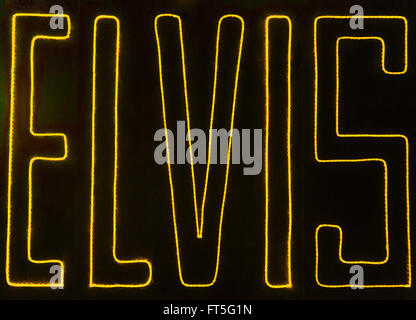 A photograph of a neon signing saying 'ELVIS'. The photograph was taken in Memphis, Tennessee. Stock Photo