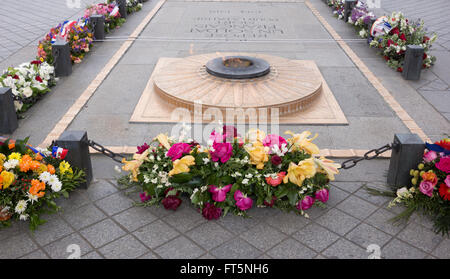 Arc de Triomphe memorial and flame for unknown soldier with many flower wreaths Stock Photo