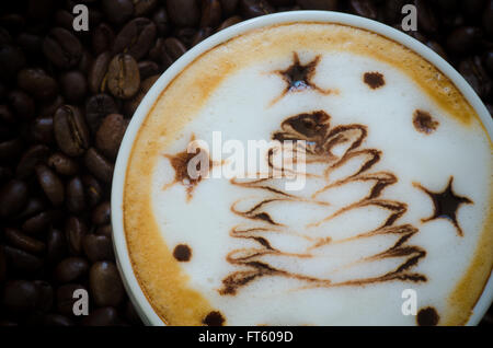 Closeup of a beautiful cup of  latte art on coffee bean background Stock Photo