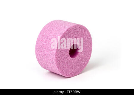 A pink abrasive wheel made out of corundum for grinding machine, photographed in the studio on a white background. Stock Photo