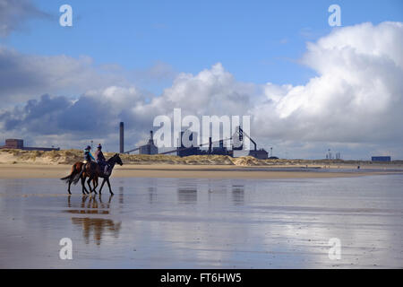 tide out with people enjoying themselves on the beach Stock Photo