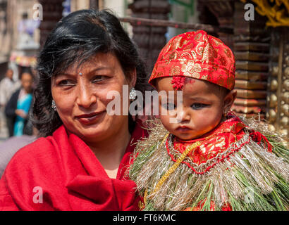 Nepal, Kathmandu.  Celebrating a six-month-old boy's eating rice for the first time, his family brings him to the temple. Stock Photo