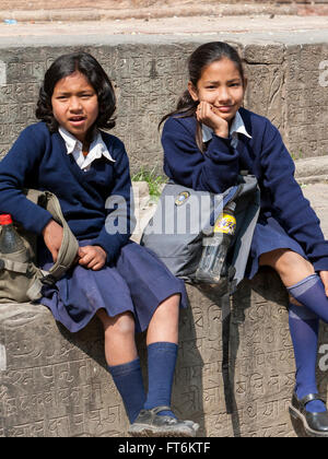 Nepal, Kathmandu.  Two Nepalese Schoolgirls in Uniform.  The one on the right is wearing a nose pin. Stock Photo
