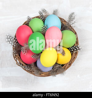 Colorful Easter eggs in basket. Top view Stock Photo
