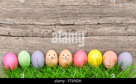 Easter eggs in green grass. Funny holidays decoration Stock Photo