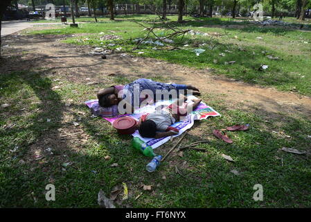 Bangladeshi homeless mother and child are taking a nap in the Sharowardi Park in Dhaka, Bangladesh. On March 23, 2016 Stock Photo