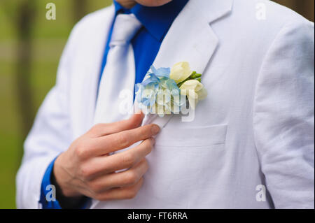 groom wears boutonniere Stock Photo