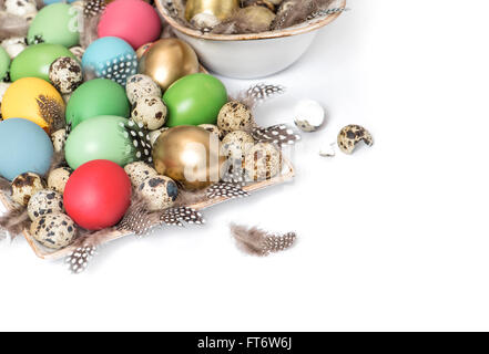 Easter decoration with eggs and feather over white background Stock Photo
