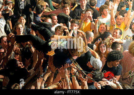 BARCELONA - MAY 30: The guitar player of Ty Segall (band) performs above the spectators (crowd surfing or mosh pit). Stock Photo