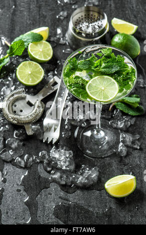 Glass of cocktail with lime, mint, ice. Tonik water, mojito, caipirinha. Top view Stock Photo