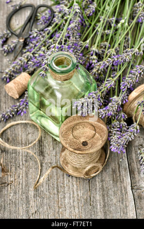 Lavender flowers with herbal oil and vintage tools. Retro style still life Stock Photo