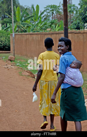 Kampala, Uganda-10 April 2017, smiling woman carrying her child in a way the do that in Africa. Stock Photo