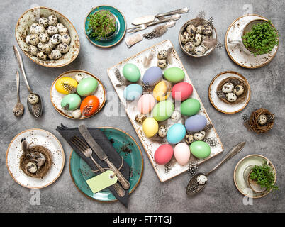 Easter decoration. Festive table place setting with colored eggs Stock Photo