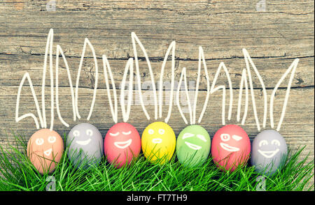 Colorful easter eggs in green grass. Funny holidays decoration. Vintage style toned picture Stock Photo