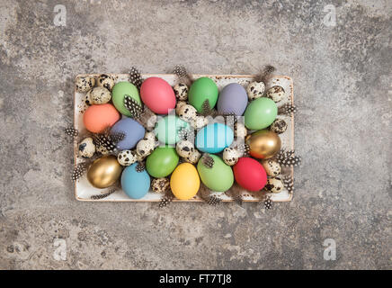 Colorful Easter eggs decoration on grey stone background Stock Photo
