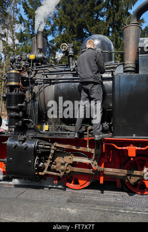 Steam engine of the Harzer narrow gauge railway getting service in station  Drei Annen Hohne, Harz Germany Stock Photo