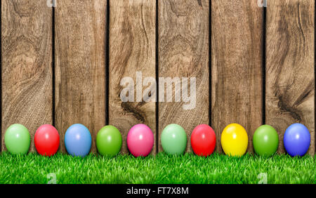 Easter holidays background. Colored eggs in green grass Stock Photo