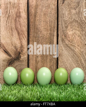 Easter holidays background. Pastel colored eggs in green grass Stock Photo