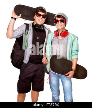 Portrait of two happy stylish skateboarders isolated on white background, best friends enjoying sport, active sportive teens Stock Photo