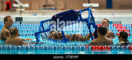 CBP Office of Air and Marine Pilots undergo inversion water training that simulates a crash in open water and how to safely exit the aircraft while submerged at the National Air Training Center in Oklahoma City, Oklahoma. Students roll over one of their own into to the pool. Photo by, James Tourtellotte. Stock Photo