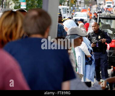 U.S. Customs and Border Protection (CBP) Officer Julio DeJesus (right) provides a law enforcement presence at a security checkpoint before Pope Francis' mass in Philadelphia September 27, 2015. CBP contributed to Papal security in Washington, D.C., New York City and Philadelphia during the Pope's weeklong visit to the United States. (CBP Photo/Steve Sapp) Stock Photo