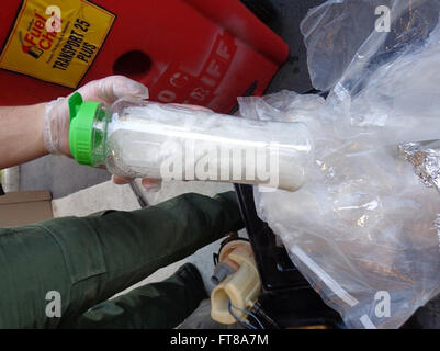 SAN CLEMENTE, Calif.— U.S. Border Patrol agents working at the U.S. Border Patrol Checkpoint in San Clemente seized more than 38 pounds of crystal methamphetamine that was stashed within plastic bottles hidden inside the gas tank of a SUV. Photo provided by: U.S. Customs and Border Protection Stock Photo