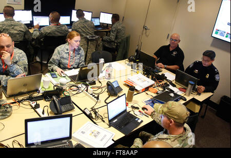 U.S. Customs and Border Protection Officers Paul J. Klein, top right, and Tanai Saefong, right, work with officers and military personnel while manning CBP's post at a multi-agency operations center in Santa Clara, Calif., as federal and local agencies ramp up security operations for Super Bowl 50 Feb. 3, 2016. (U.S. Customs and Border Protection Photo by Glenn Fawcett) Stock Photo