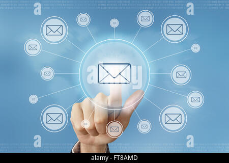 business hand pushing e-mail button with global networking concept Stock Photo