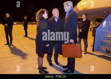 U.S. Secretary of State John Kerry speaks with U.S. Embassy Berlin Deputy Chief of Mission Kent Logsdon and U.S. Consulate General Munich Consul General Jennifer Gavito after disembarking from his airplane on February 10, 2016, following a flight from Andrews Air Force Base in Camp Springs, Maryland, to Munich International Airport in Munich, Germany, so he can attend meetings focused on Syria and also address the Munich Security Conference. [State Department photo/ Public Domain] Stock Photo