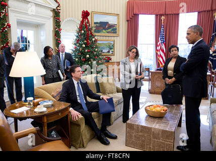 Dec. 3, 2015 'Following a meeting to discuss the latest information on the mass shootings in San Bernardino, Calif., the President has some last words with, from left, Chief of Staff Denis McDonough, National Security Advisor Susan E. Rice, FBI Director James Comey (seated on sofa), Alejandro N. Mayorkas, Deputy Secretary of Homeland Security, Lisa Monaco, Assistant to the President for Homeland Security and Counterterrorism, and Attorney General Loretta Lynch.' (Official White House Photo by Pete Souza) Stock Photo