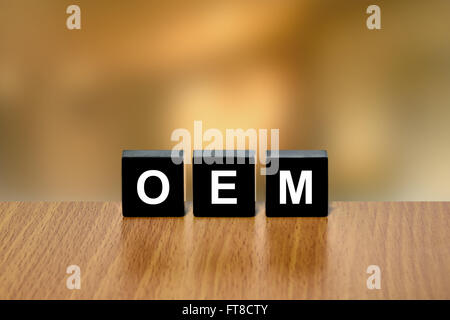 OEM or Original Equipment Manufacturer on black block with blurred background Stock Photo