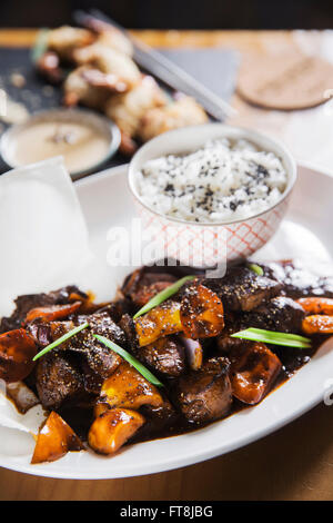 Asian dish - beef in black pepper sauce with vegetables and rice Stock Photo