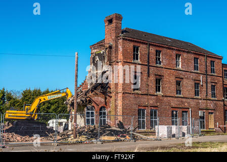 An old building being demolished following fire damage. Stock Photo