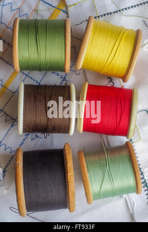 Colored Cottons. A variety of colored cottons on bobbins. Stock Photo