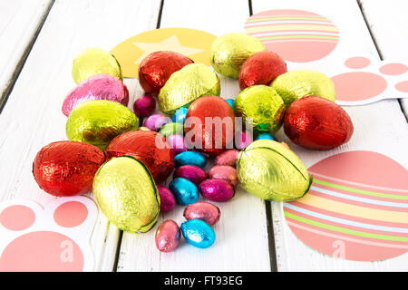 Colorful Easter eggs against a white wood background Stock Photo