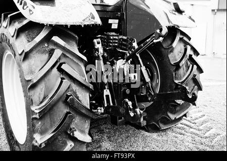 Wheels of back view of new tractor in snowy weather Stock Photo