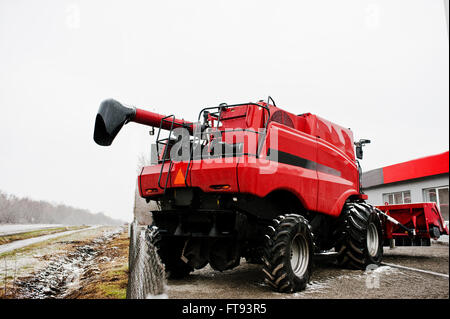 Back view of new red combine harvester at snowy weather Stock Photo