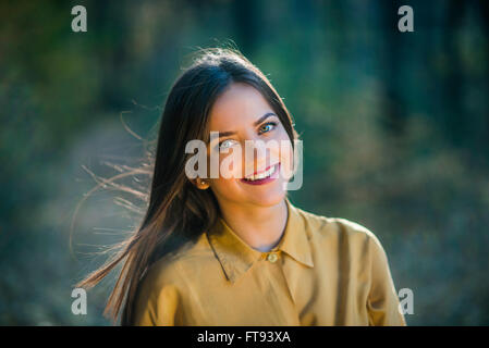 Portrait of smiling girl with bright eyes. Portrait of a beatiful smiling teenager girl with bright eyes wearing yellow shirt in Stock Photo