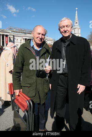 London, UK. 25th March, 2016. Under a bright blue sky and sunshine ,the passion of Jesus  show produced  by Sir Peter Hutley.,right, seen here with The Archbishop of Westminster. Cardinal Vincent Nichols,left , in Trafalgar Square Good Friday Credit:  Paul Quezada-Neiman/Alamy Live News Stock Photo