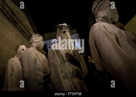 San Lorenzo Maggiore, Italy. 25th Mar, 2016. On the afternoon of Good Friday, during the Holy Week held the Penitential procession of the 'Battenti'. Dozens of hooded brothers with a crown of thorns on their heads, parade through the streets of the village, flagellating themselves as a sign of penance with discipline (whip with iron plates and chains). Hundreds of Easter processions take place in southern Italy during Holy Week, drawing thousands of visitors. Credit:  Michele Amoruso/Pacific Press/Alamy Live News Stock Photo