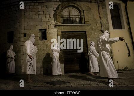 San Lorenzo Maggiore, Italy. 25th Mar, 2016. On the afternoon of Good Friday, during the Holy Week held the Penitential procession of the 'Battenti'. Dozens of hooded brothers with a crown of thorns on their heads, parade through the streets of the village, flagellating themselves as a sign of penance with discipline (whip with iron plates and chains). Hundreds of Easter processions take place in southern Italy during Holy Week, drawing thousands of visitors. Credit:  Michele Amoruso/Pacific Press/Alamy Live News Stock Photo