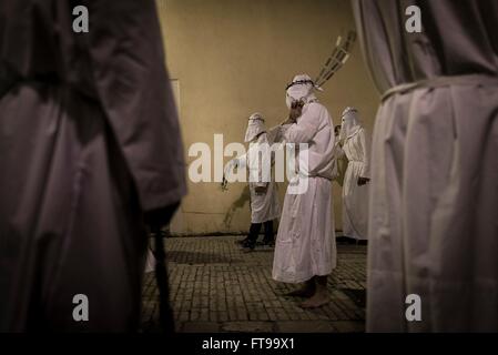 San Lorenzo Maggiore, Italy. 25th Mar, 2016. On the afternoon of Good Friday, during the Holy Week held the Penitential procession of the 'Battenti'. Dozens of hooded brothers with a crown of thorns on their heads, parade through the streets of the village, flagellating themselves as a sign of penance with discipline (whip with iron plates and chains). Hundreds of Easter processions take place in southern Italy during Holy Week, drawing thousands of visitors. Credit:  Michele Amoruso/Pacific Press/Alamy Live News Stock Photo