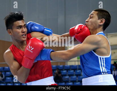 Qian'an, China's Hebei Province. 26th Mar, 2016. Anvar Yunusov(R) of Tajikistan competes with Farrand Papendang of Indonesia during their men's 52kg category of Asia/Oceania Zone boxing event qualifier for 2016 Rio Olympic Games in Qian'an, north China's Hebei Province, March 26, 2016. Anvar Yunusov won the match 3-0. Credit:  Yang Shiyao/Xinhua/Alamy Live News Stock Photo
