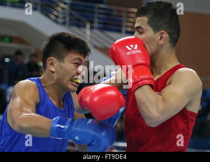 Qian'an, China's Hebei Province. 26th Mar, 2016. Odai Riyad Adel Alhindawi(R) of Jordan competes with Vinky Montolalu of Indonesia during their men's 64kg category of Asia/Oceania Zone boxing event qualifier for 2016 Rio Olympic Games in Qian'an, north China's Hebei Province, March 26, 2016. Odai Riyad Adel Alhindawi won the match 3-0. Credit:  Yang Shiyao/Xinhua/Alamy Live News Stock Photo