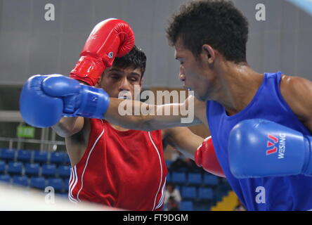 Qian'an, China's Hebei Province. 26th Mar, 2016. Hanurdeen Hamid(L) of Singapore competes with Mario Blasius Kali of Indonesia during their men's 52kg category of Asia/Oceania Zone boxing event qualifier for 2016 Rio Olympic Games in Qian'an, north China's Hebei Province, March 26, 2016. Hanurdeen Hamid won the match 3-0. Credit:  Yang Shiyao/Xinhua/Alamy Live News Stock Photo