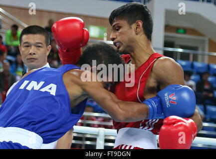 Qian'an, China's Hebei Province. 26th Mar, 2016. Hanurdeen Hamid(R) of Singapore competes with Mario Blasius Kali of Indonesia during their men's 52kg category of Asia/Oceania Zone boxing event qualifier for 2016 Rio Olympic Games in Qian'an, north China's Hebei Province, March 26, 2016. Hanurdeen Hamid won the match 3-0. Credit:  Yang Shiyao/Xinhua/Alamy Live News Stock Photo