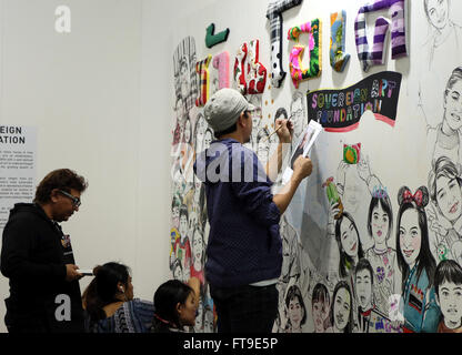 Hong Kong. 26th Mar, 2016. An artist draws at the Contemporary Art Expo in Hong Kong, south China, March 26, 2016. More than 100 galleries from 21 countries and regions attended the Expo. Credit:  Li Peng/Xinhua/Alamy Live News Stock Photo