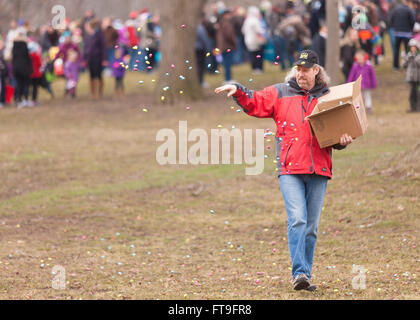 St. Thomas, Ontario, Canada. 26th Mar, 2016. A St. Thomas Kin Club member distributes some of the more than 500lbs of chocolate in Pinafore Park prior to the Easter Egg Hunt. Credit:  Mark Spowart/Alamy Live News Stock Photo